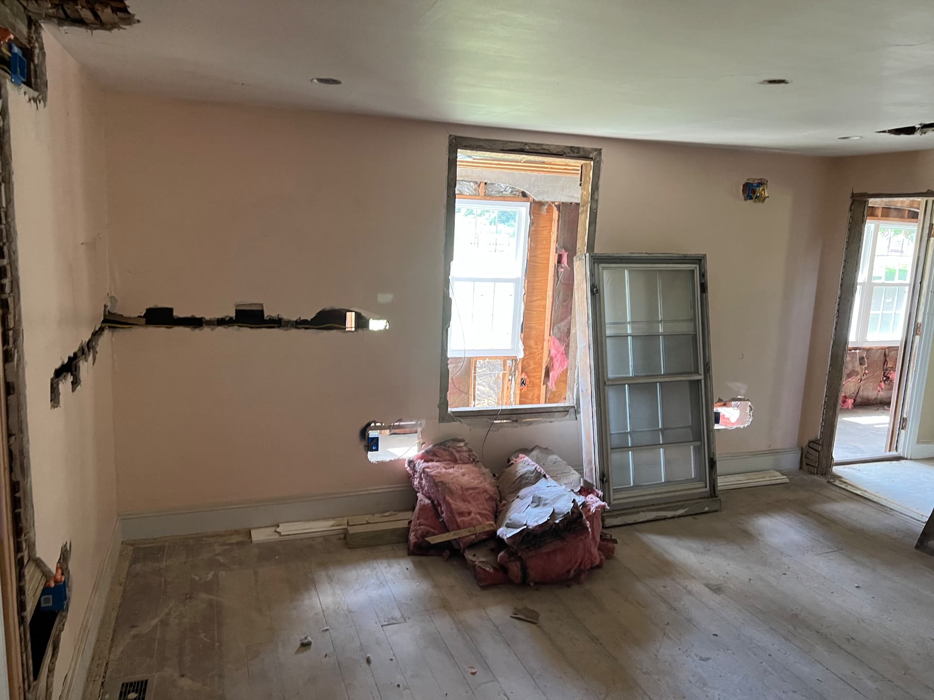 Bedroom walls opened for wiring with old windows removed for replacements