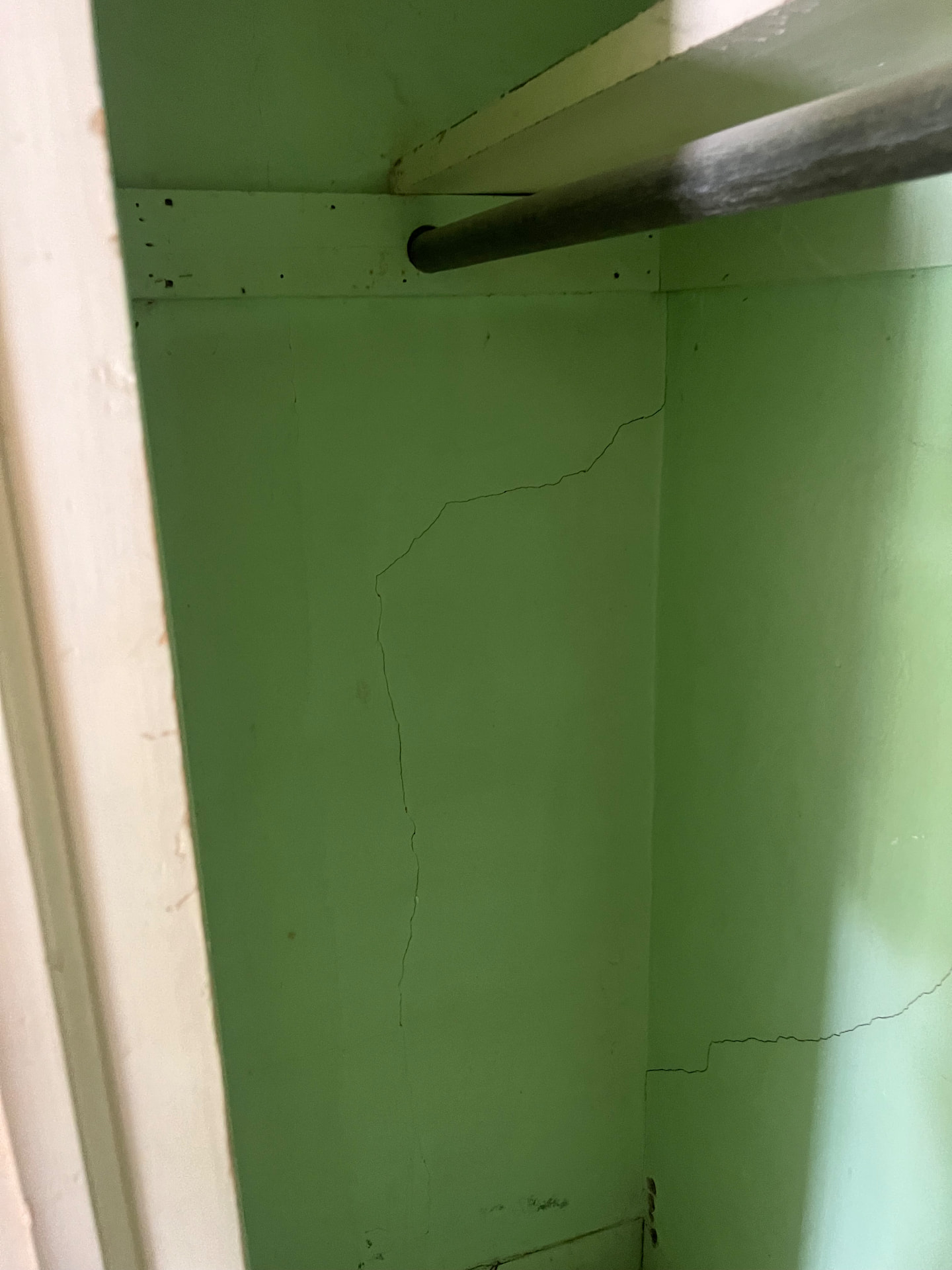 Cracked plaster in a back stairwell before the walls were rebuilt