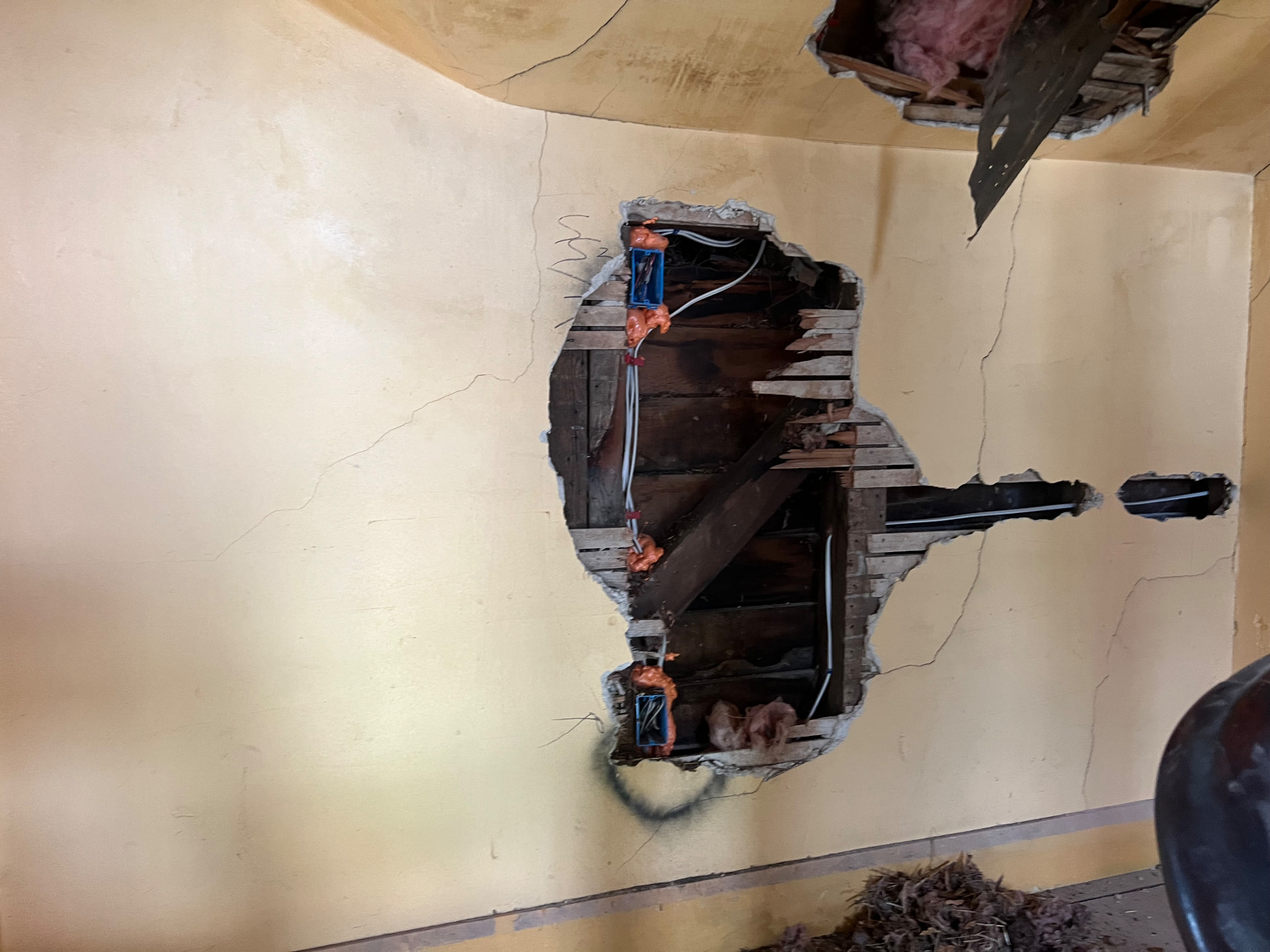 Plaster opened to the original hand-split lath to run new electrical boxes