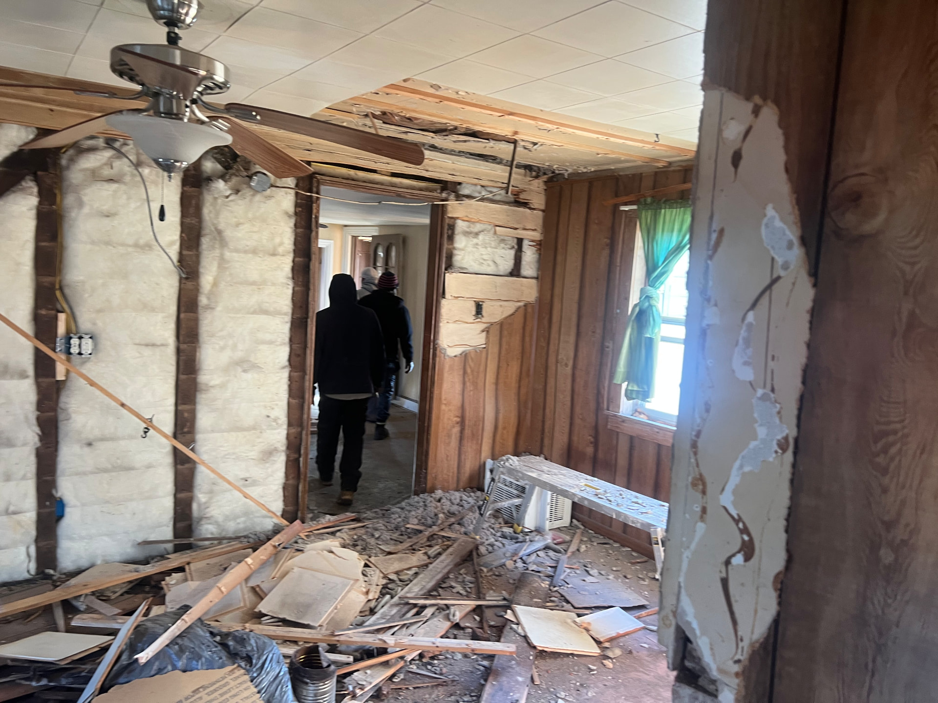 Interior walls opened up during demolition, debris across the floor