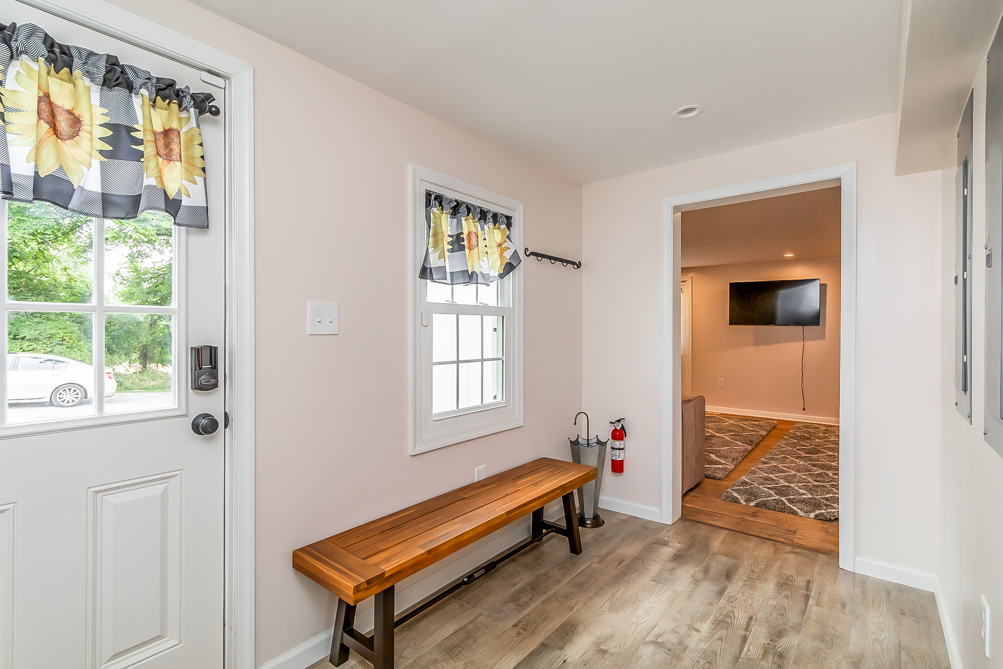 Mudroom entry with a wood bench and keypad door