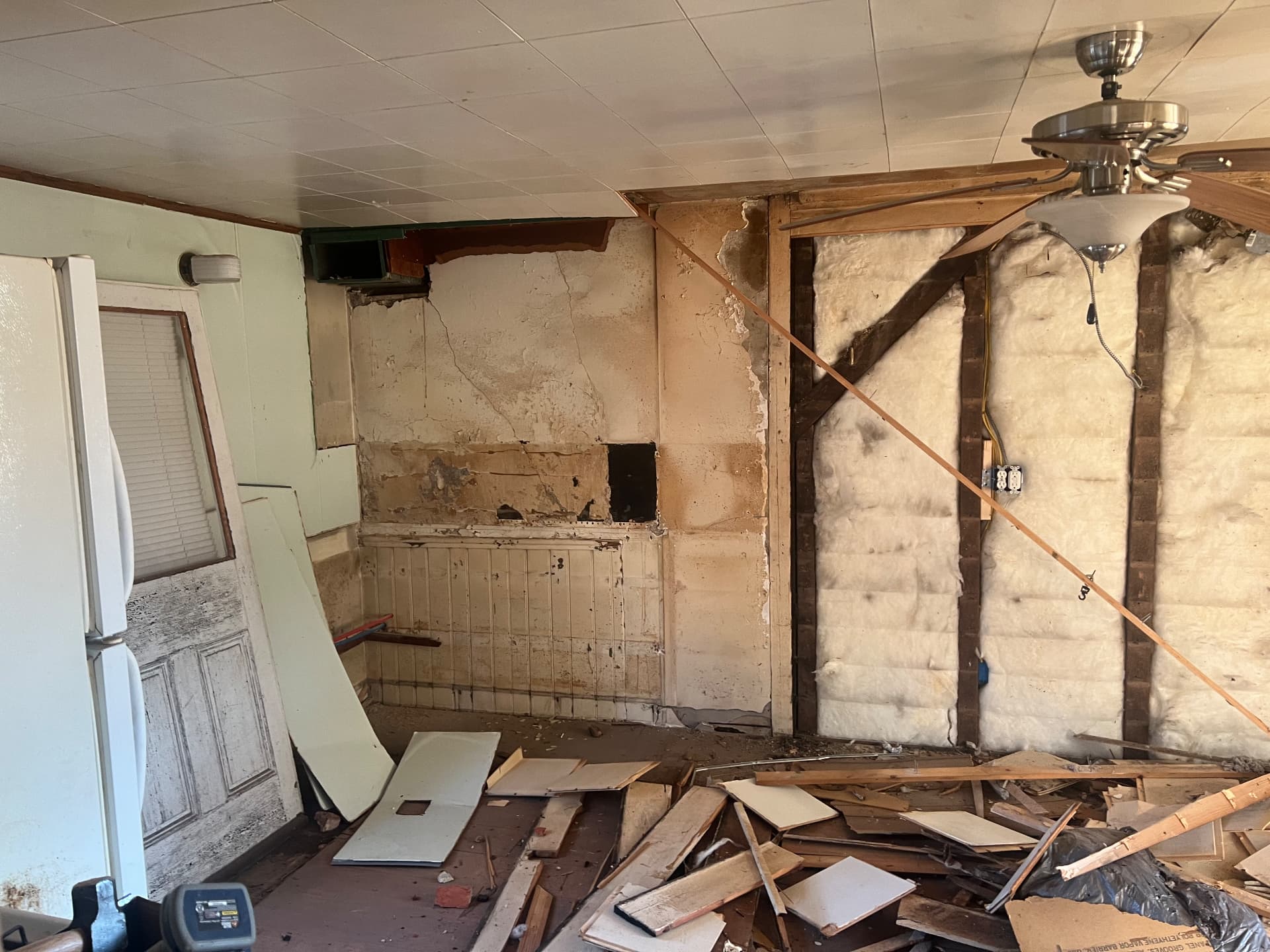 Kitchen wall stripped to the studs and original plaster during demolition