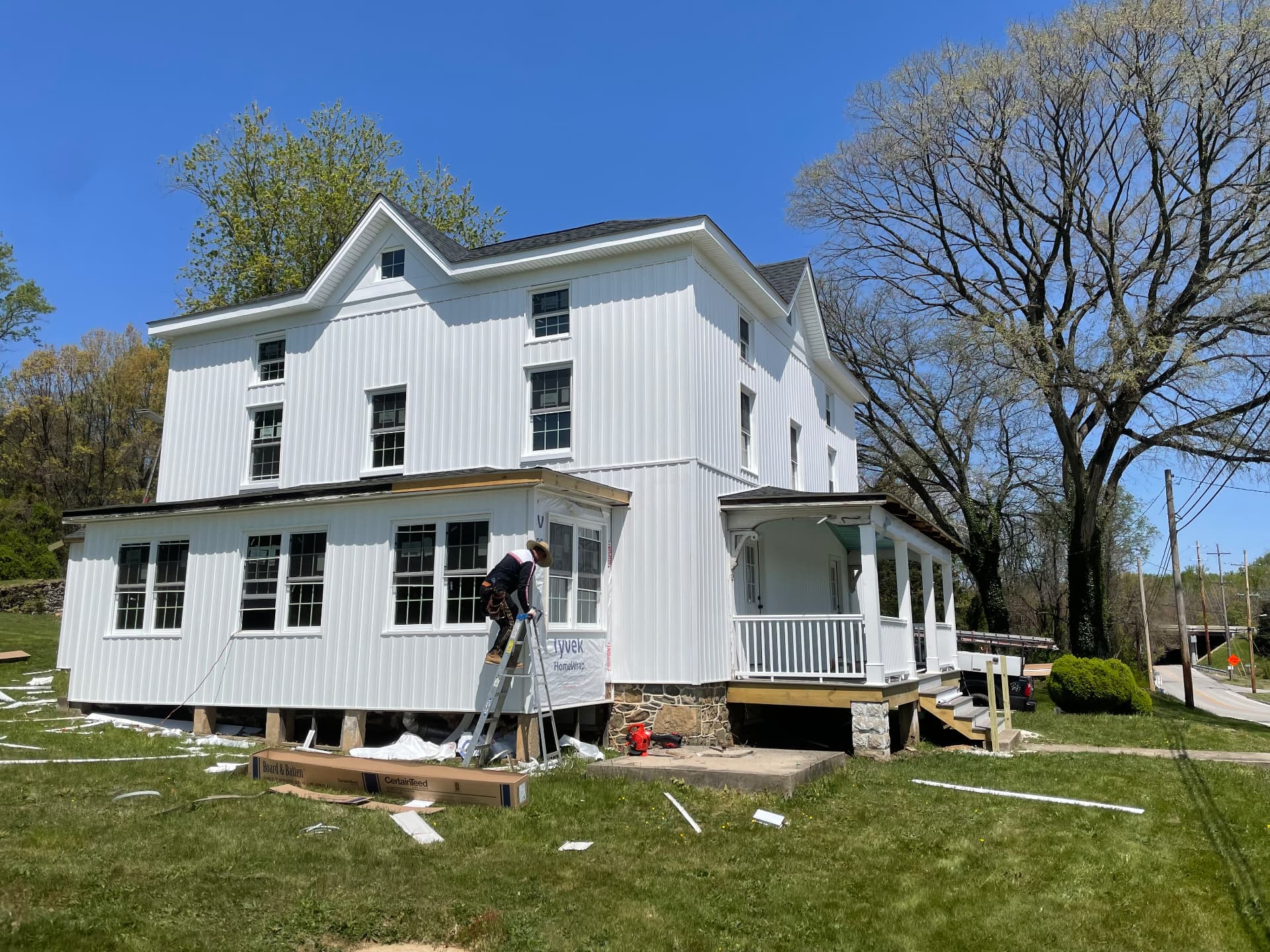 New siding wrapping the sunroom and original porch