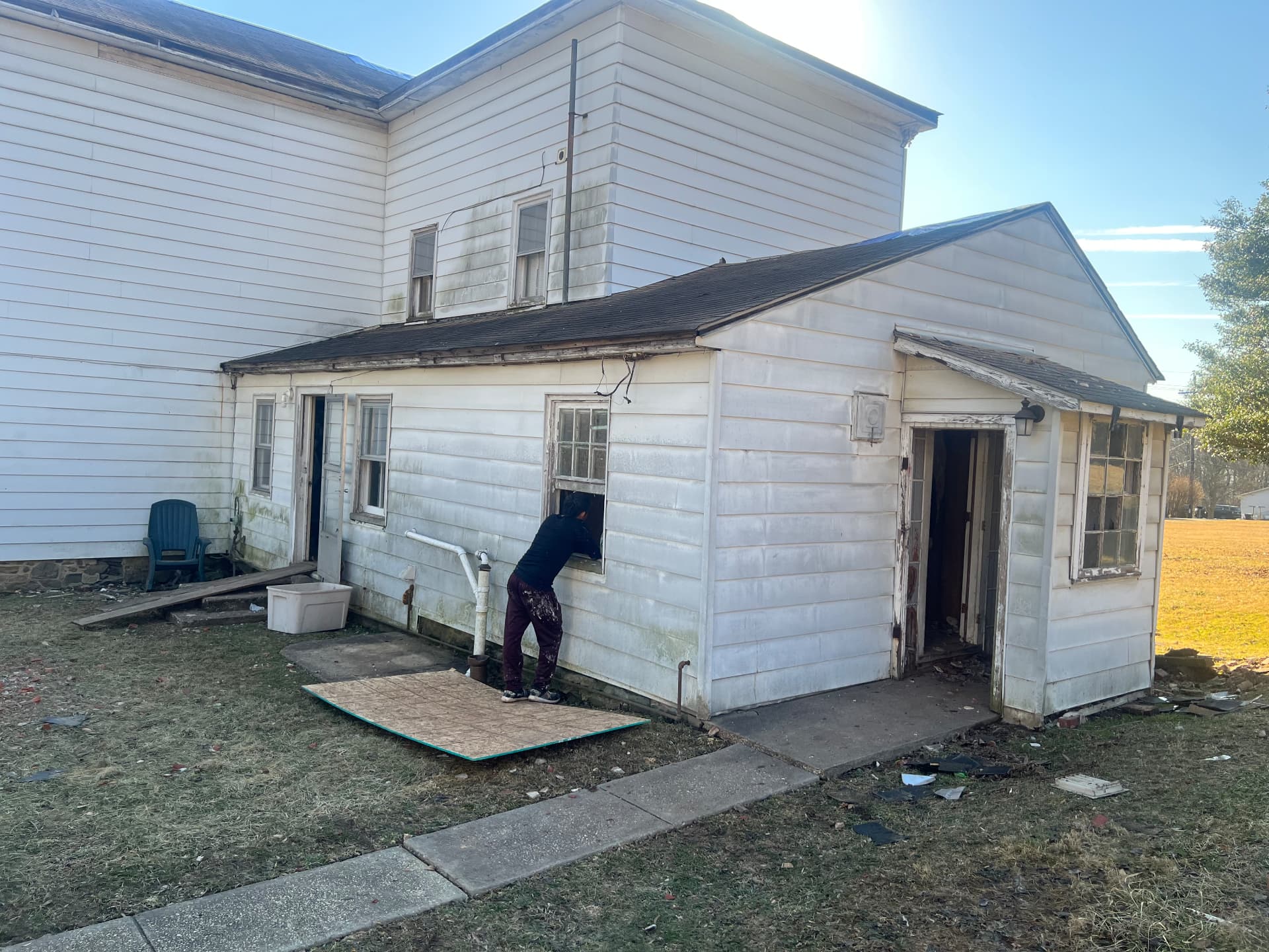 Rear addition before restoration, boarded windows and stripped doorways during demolition