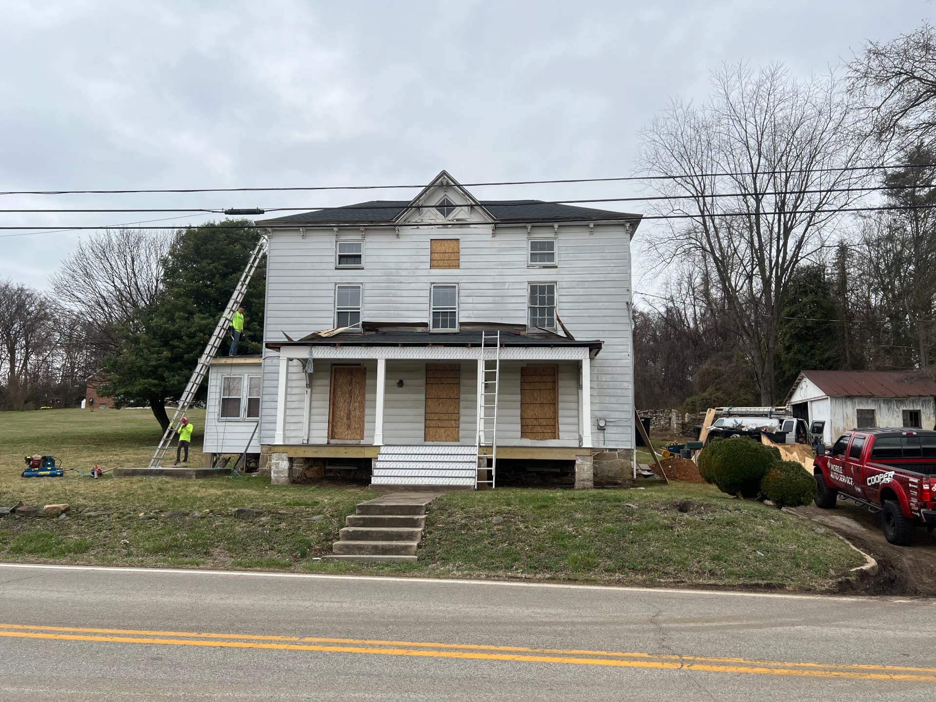 New roof going on at the front of the house while the porch is rebuilt