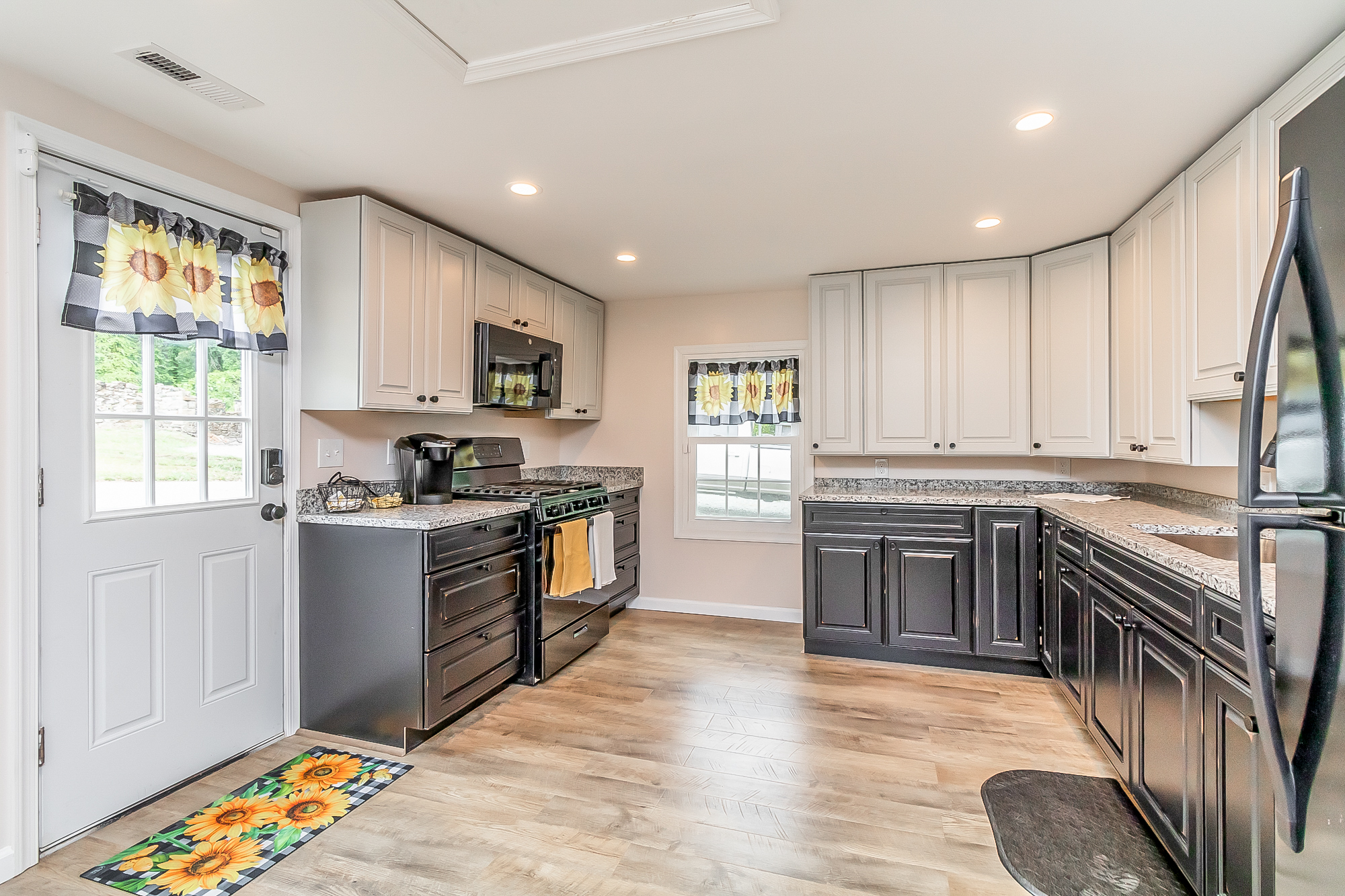 Kitchen with gas range and the side door out to the stone wall