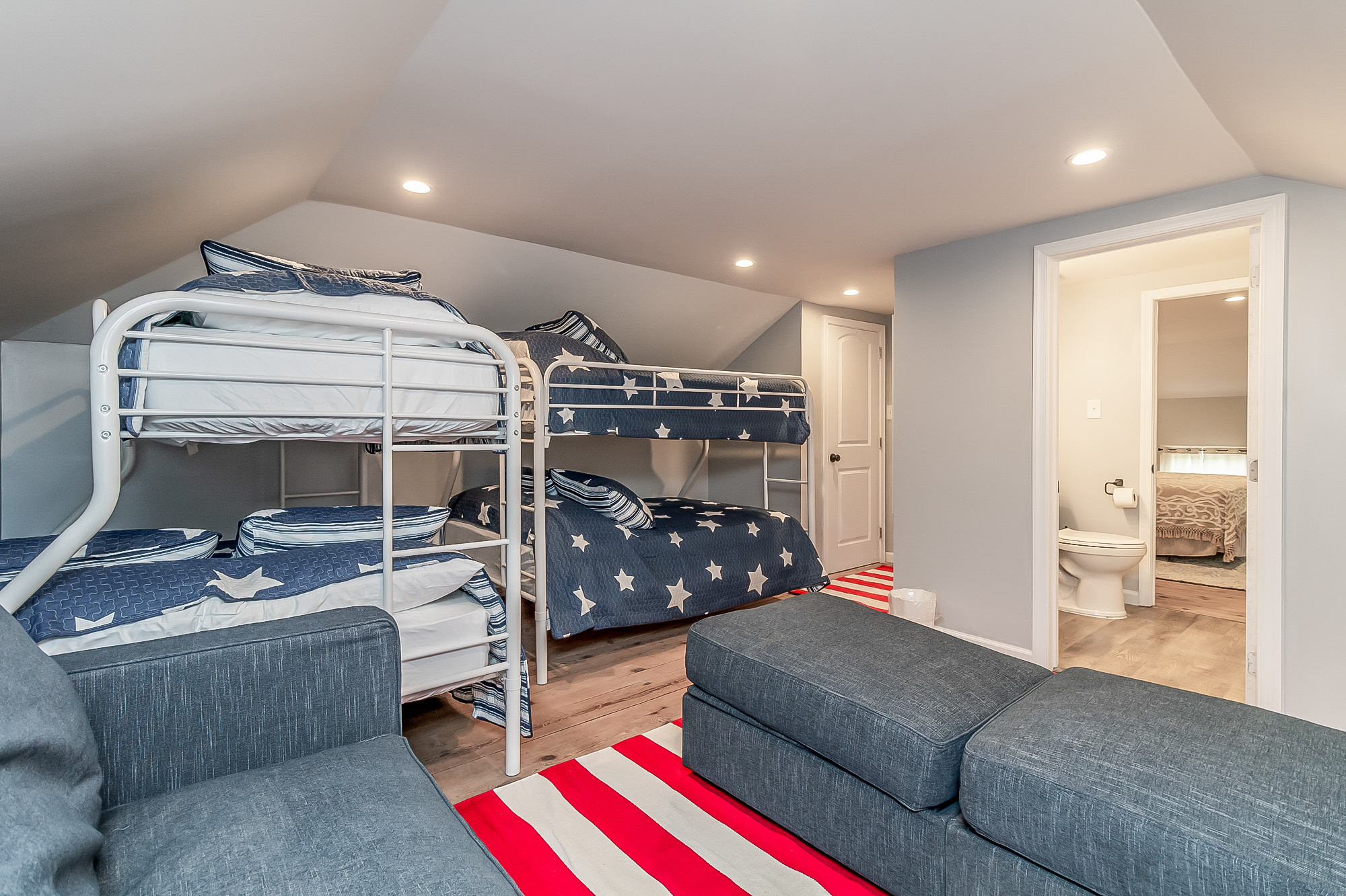 Bunk room with four beds and a connecting bathroom