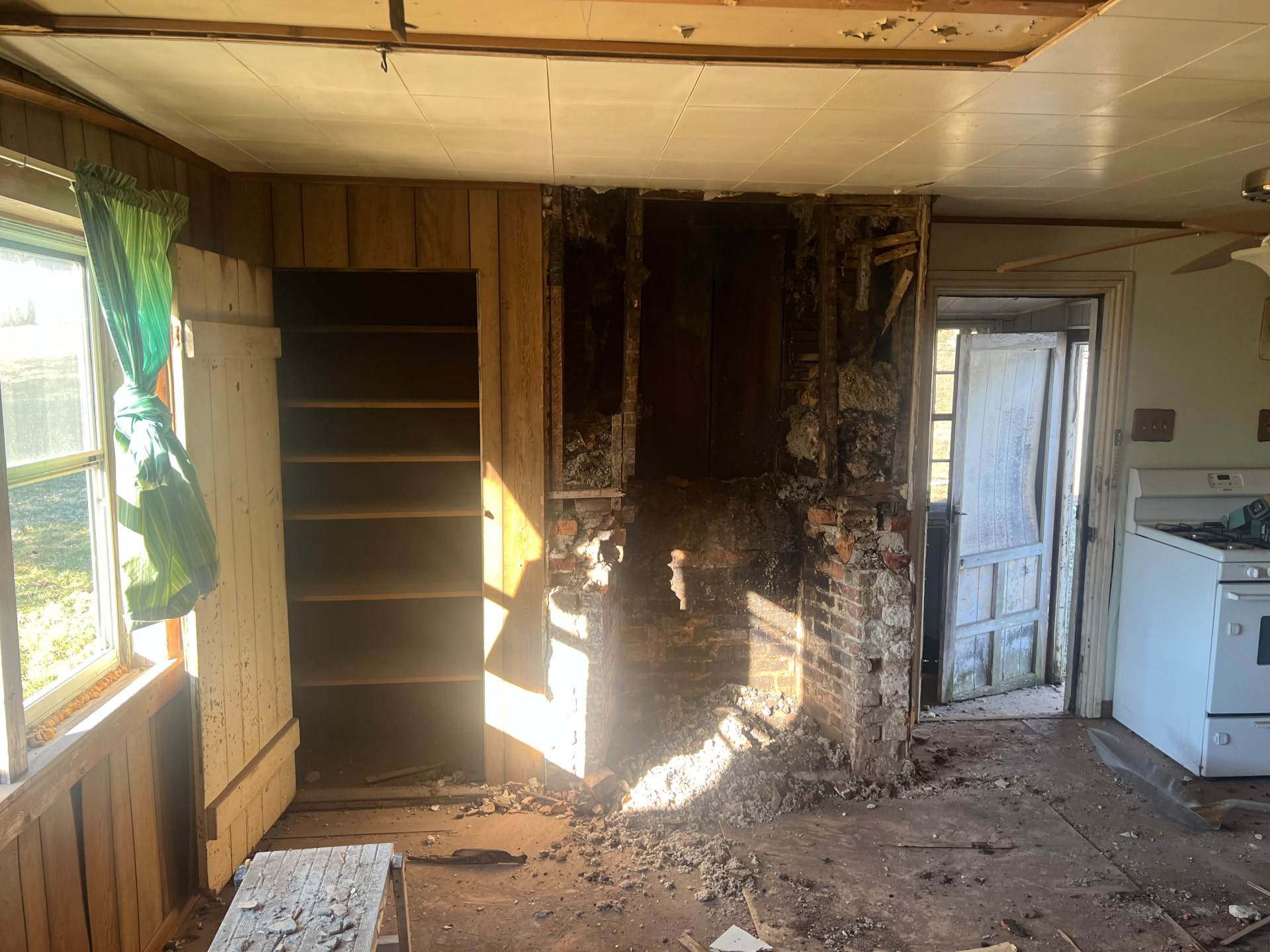 Original brick chimney uncovered behind paneling during demolition