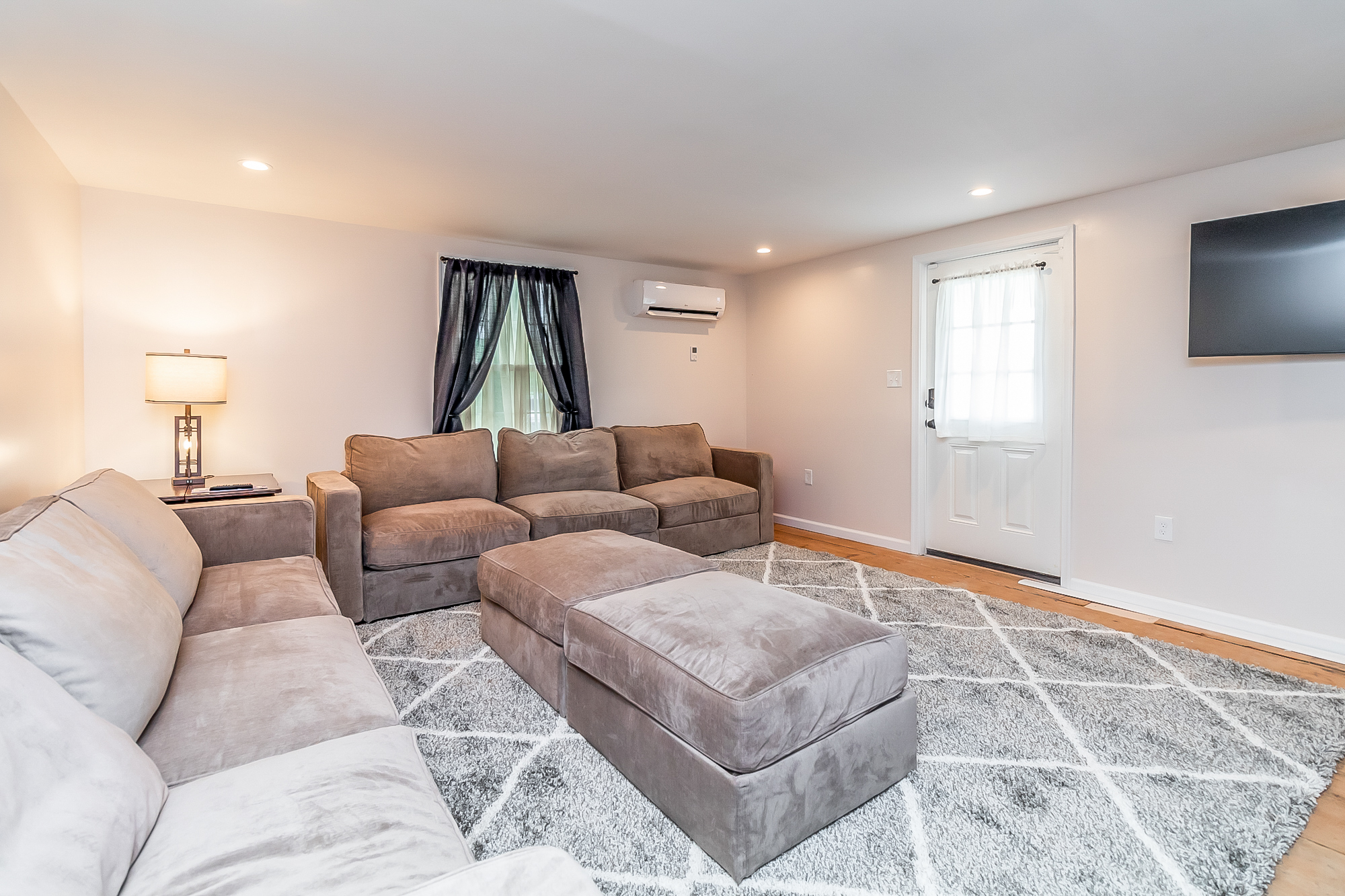 Lounge with sectional seating and a wall-mounted TV