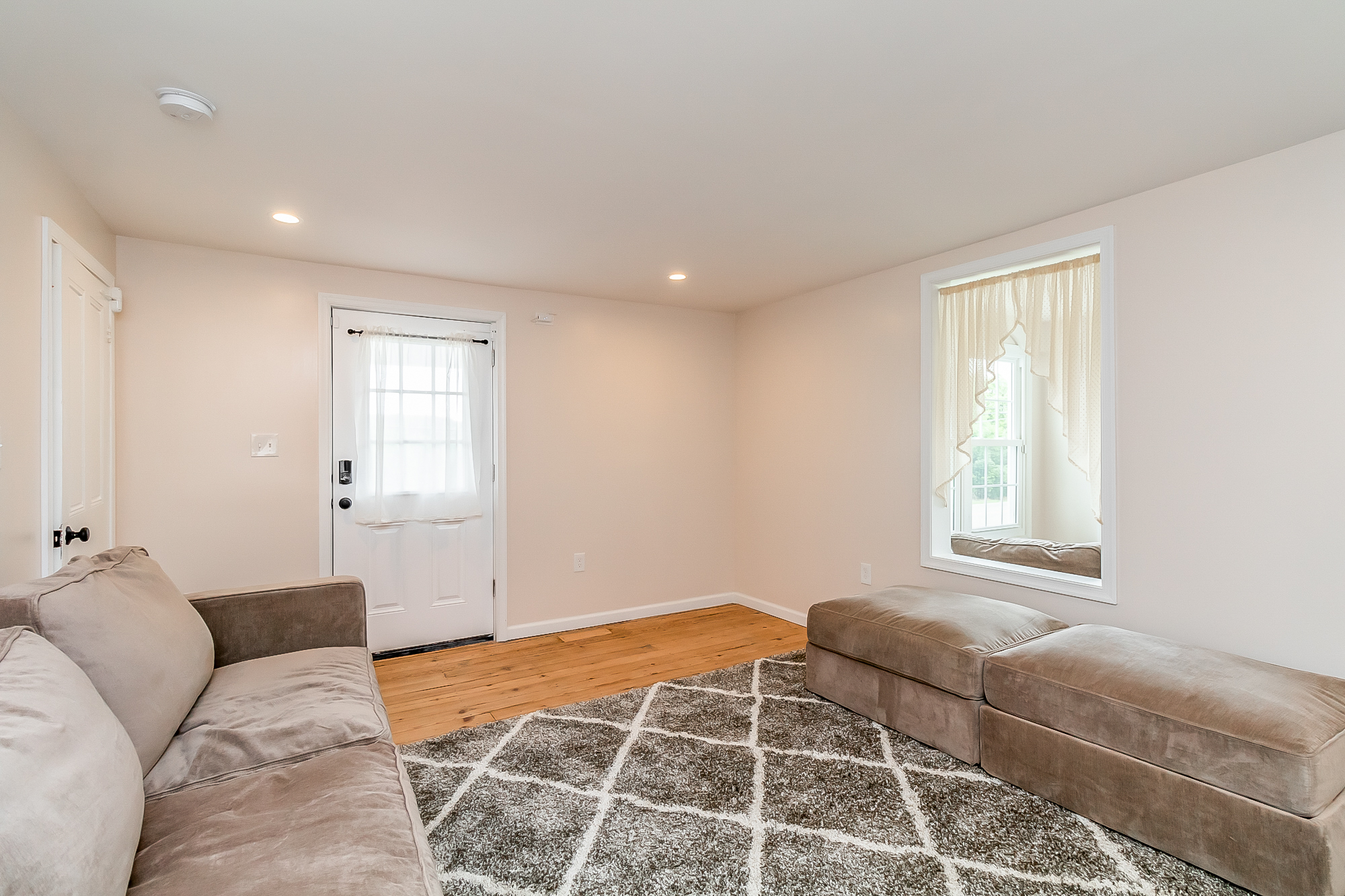 Family room with restored original pine floors and a keypad side entry