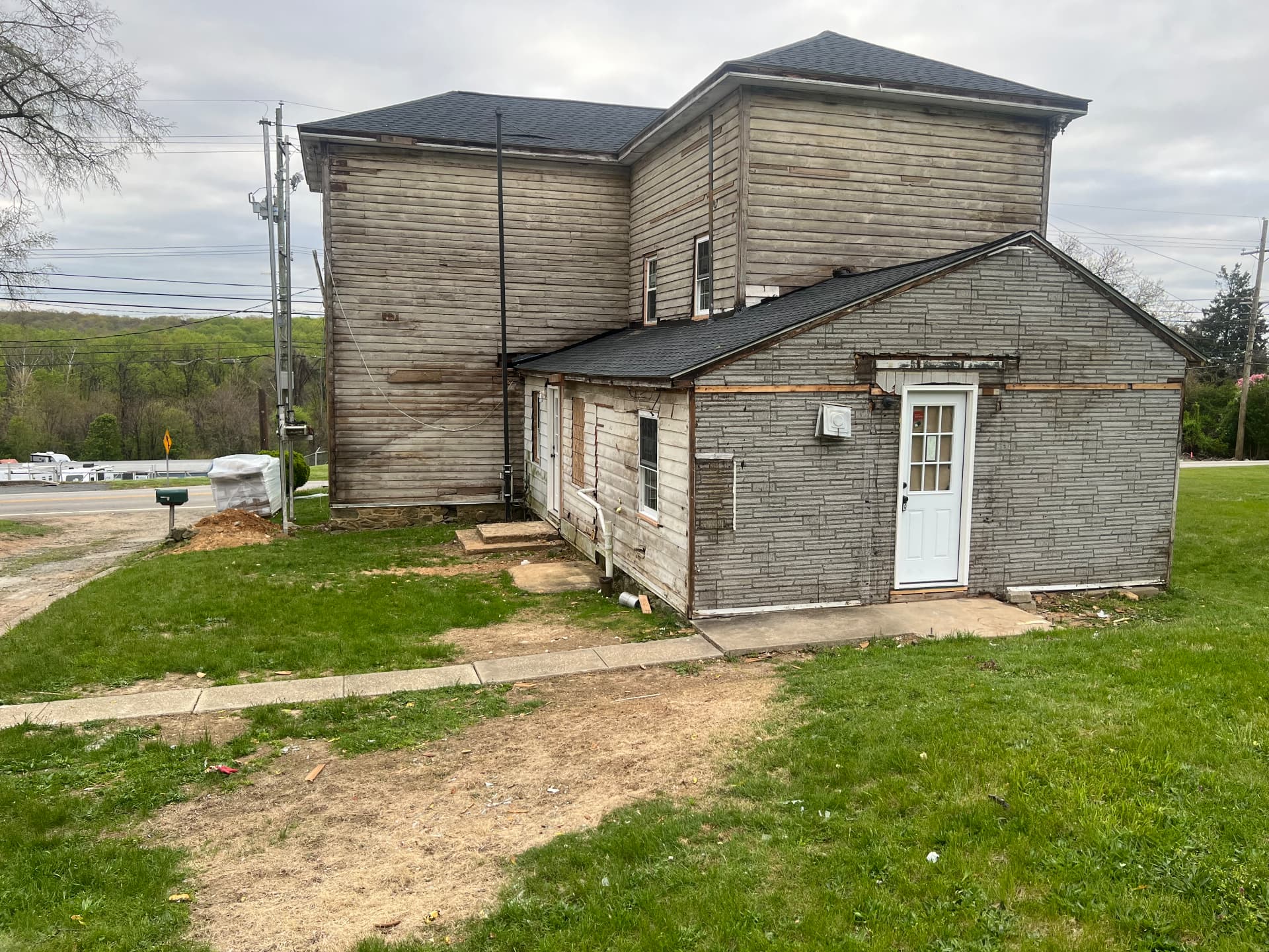 Rear additions with old siding removed down to the original boards