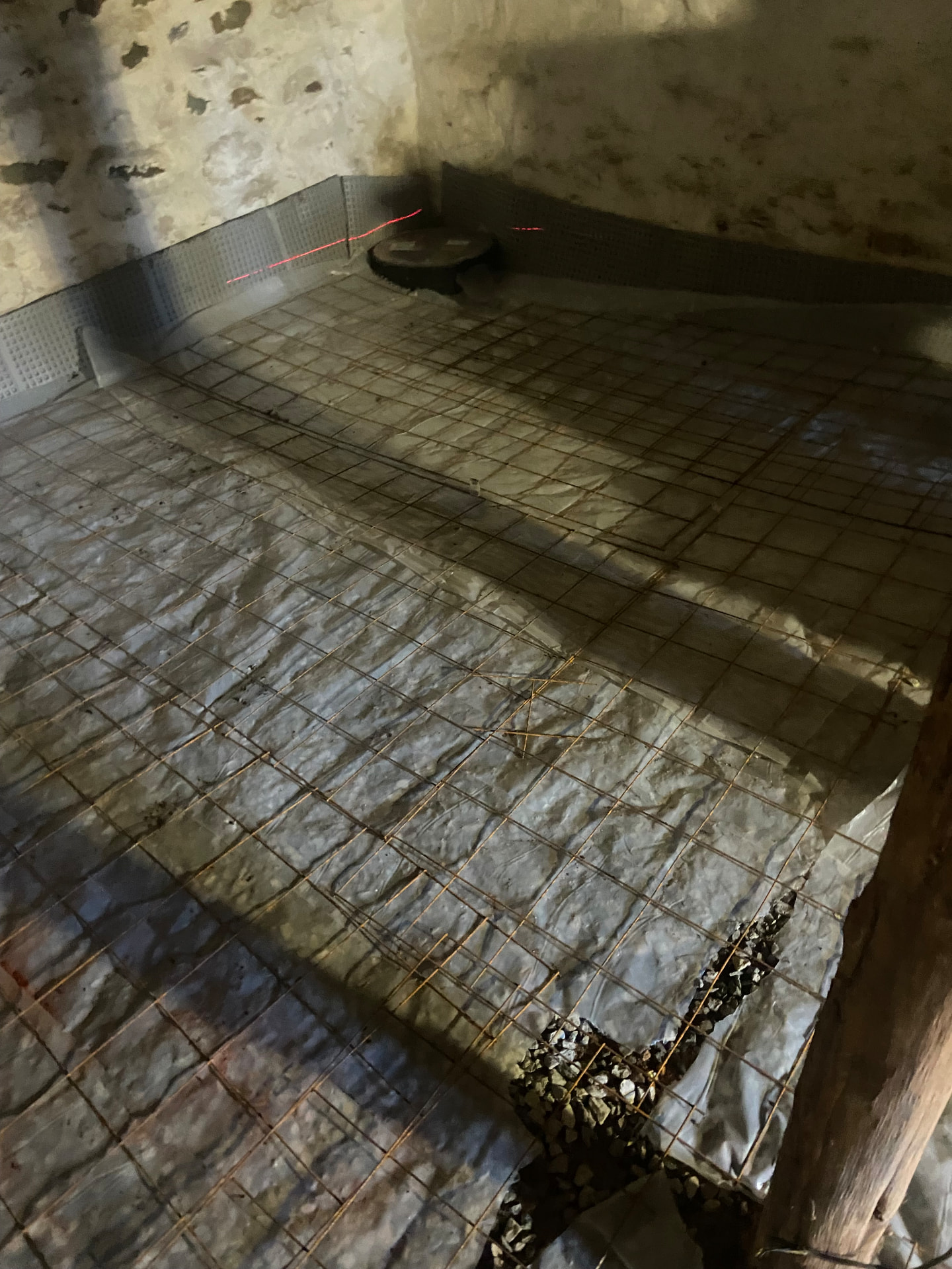 New basement floor prepared with vapor barrier and steel reinforcement