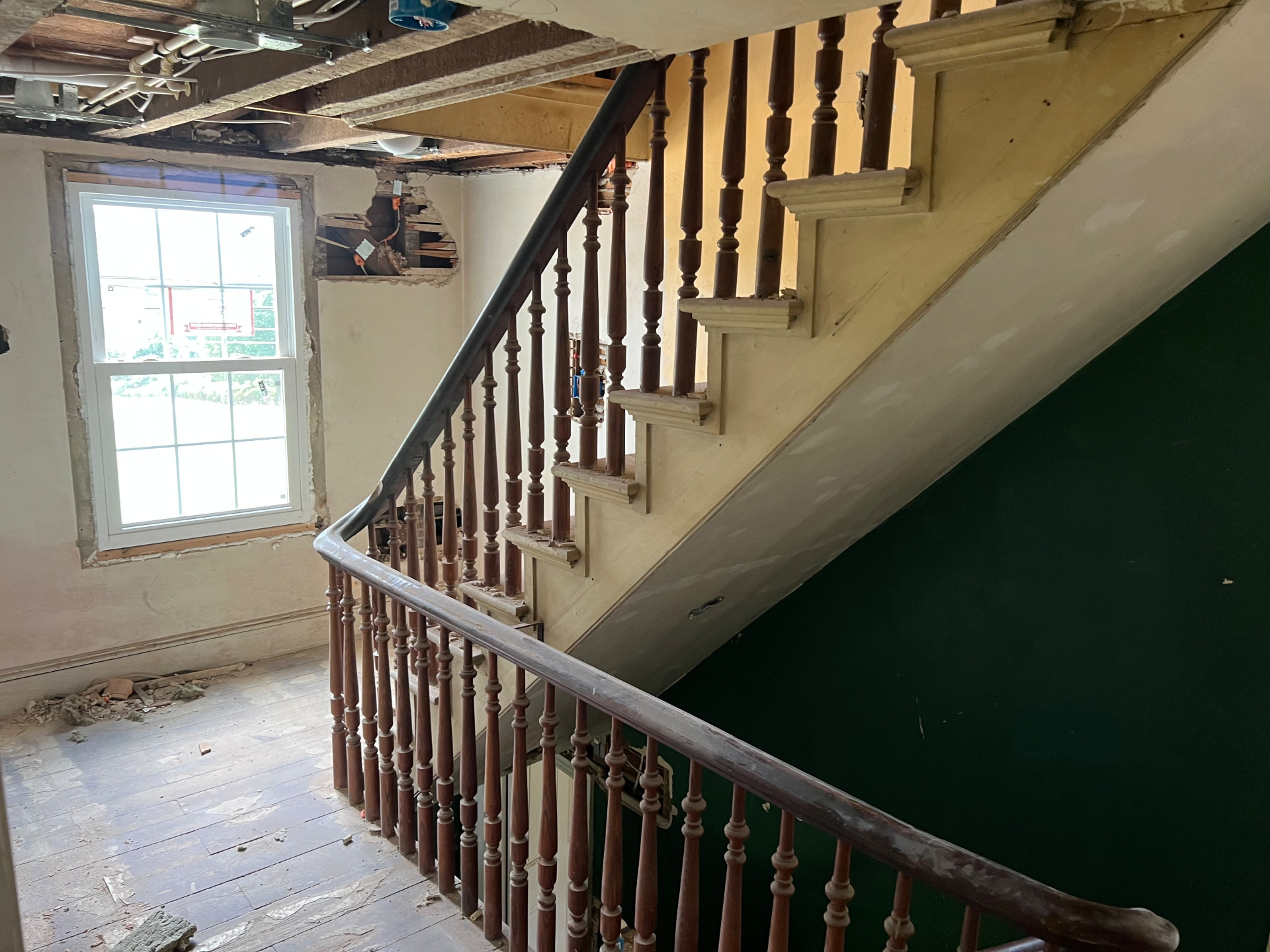 The original staircase and turned banister saved through the renovation