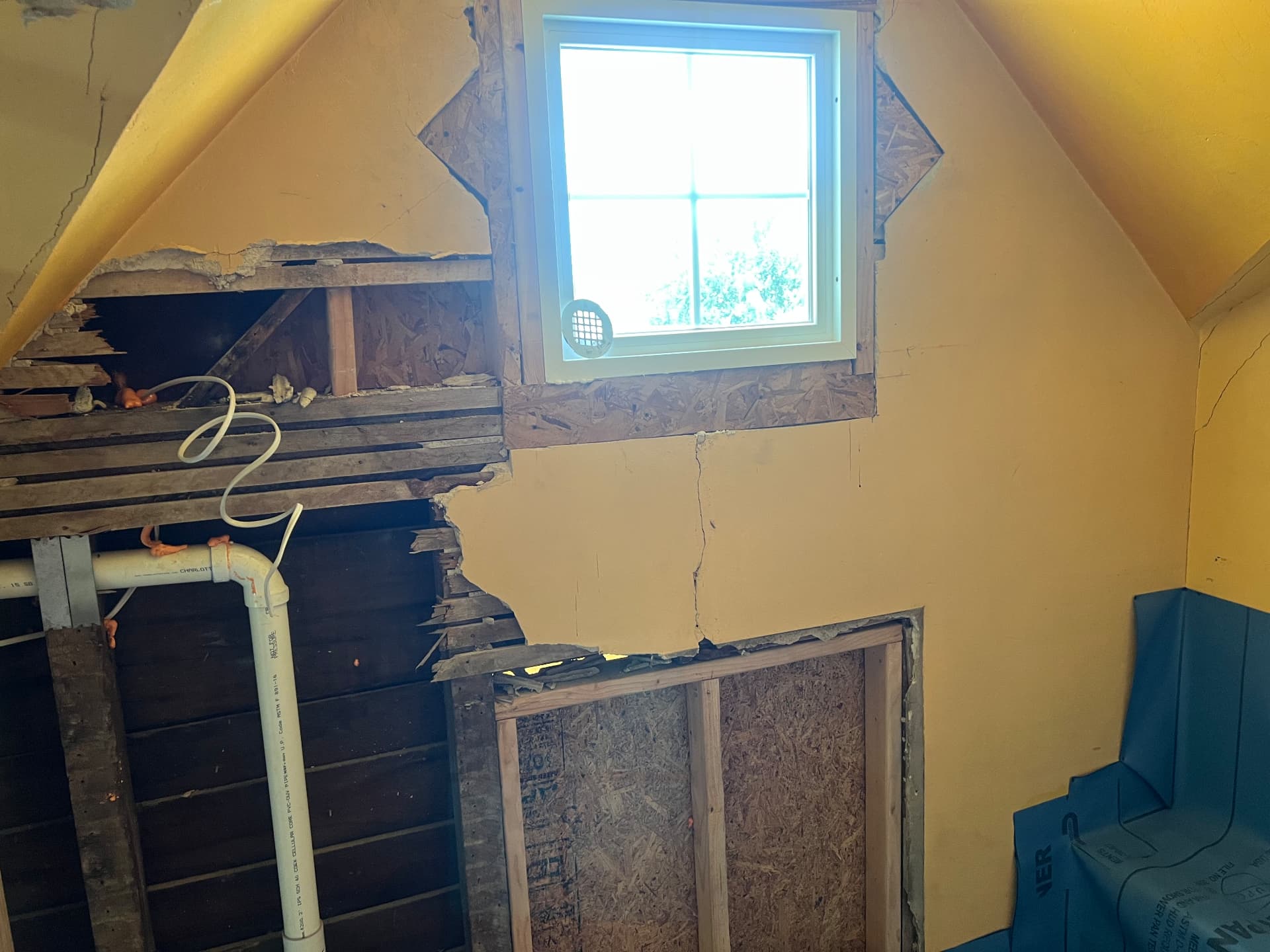 Upstairs walls opened to the original framing as new plumbing is run for a bathroom