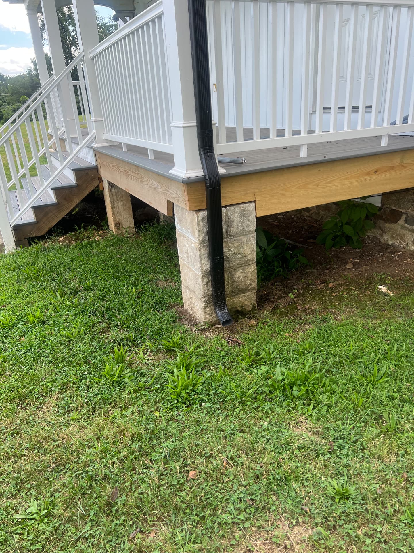 Rebuilt porch and steps resting on the original cut-stone piers