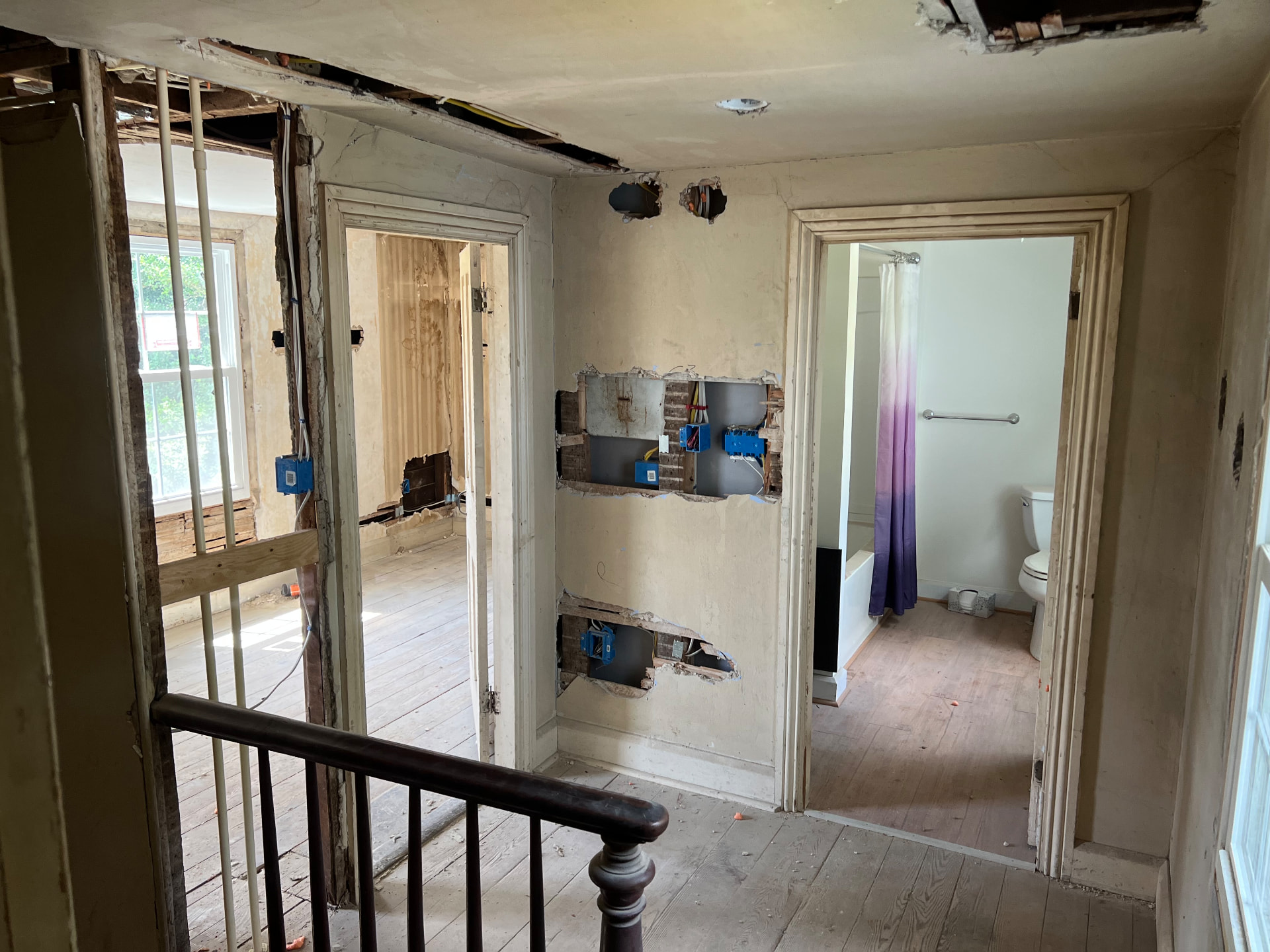 Upstairs landing with walls opened for new electrical boxes beside the old bathroom