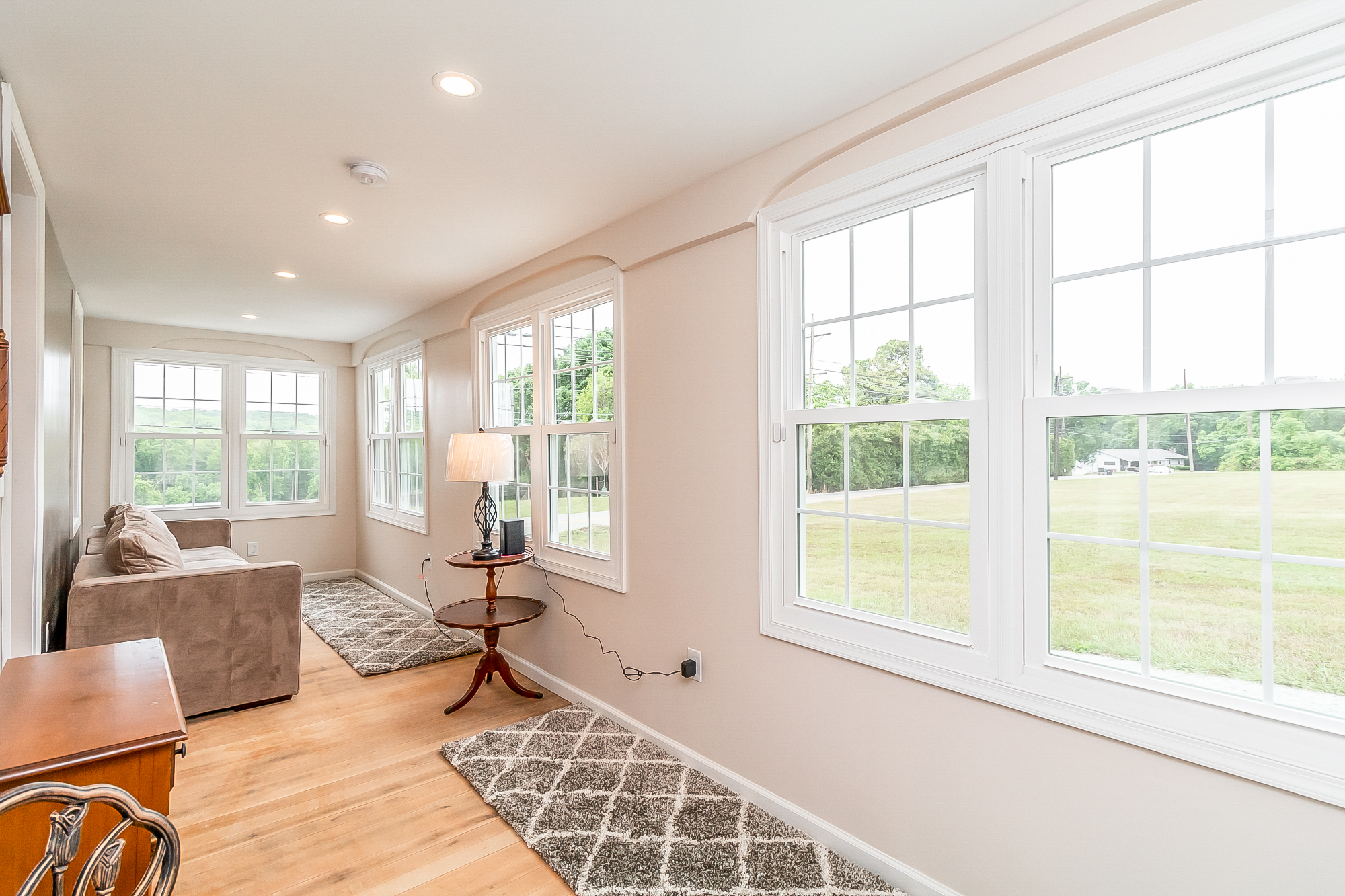 Finished sunroom lined with new windows over the back field