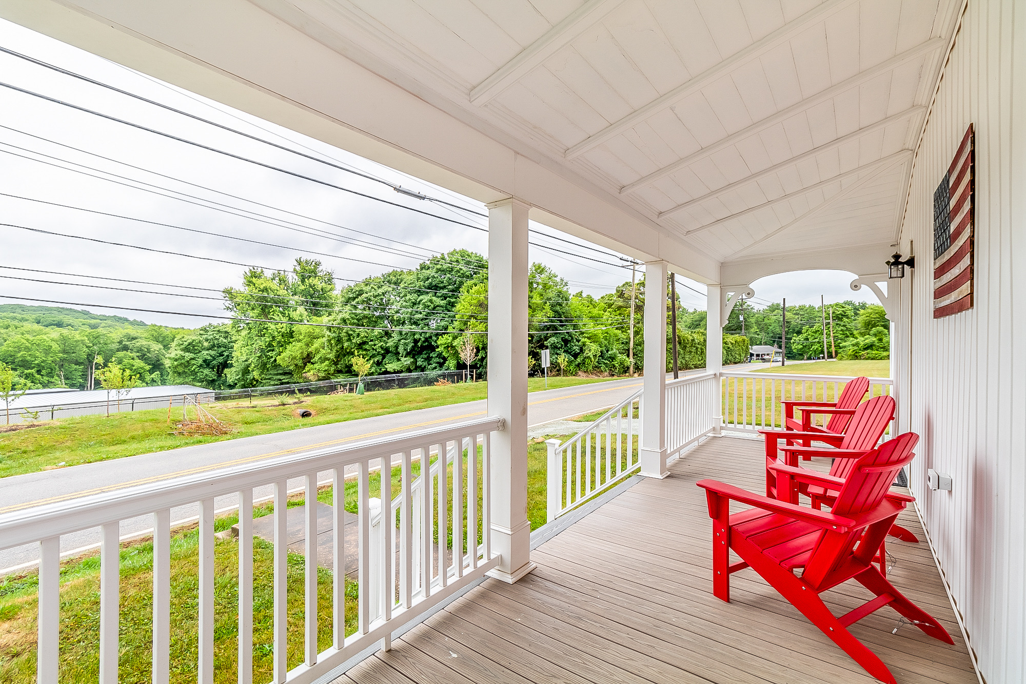 Wraparound porch looking out over the railings to the green countryside