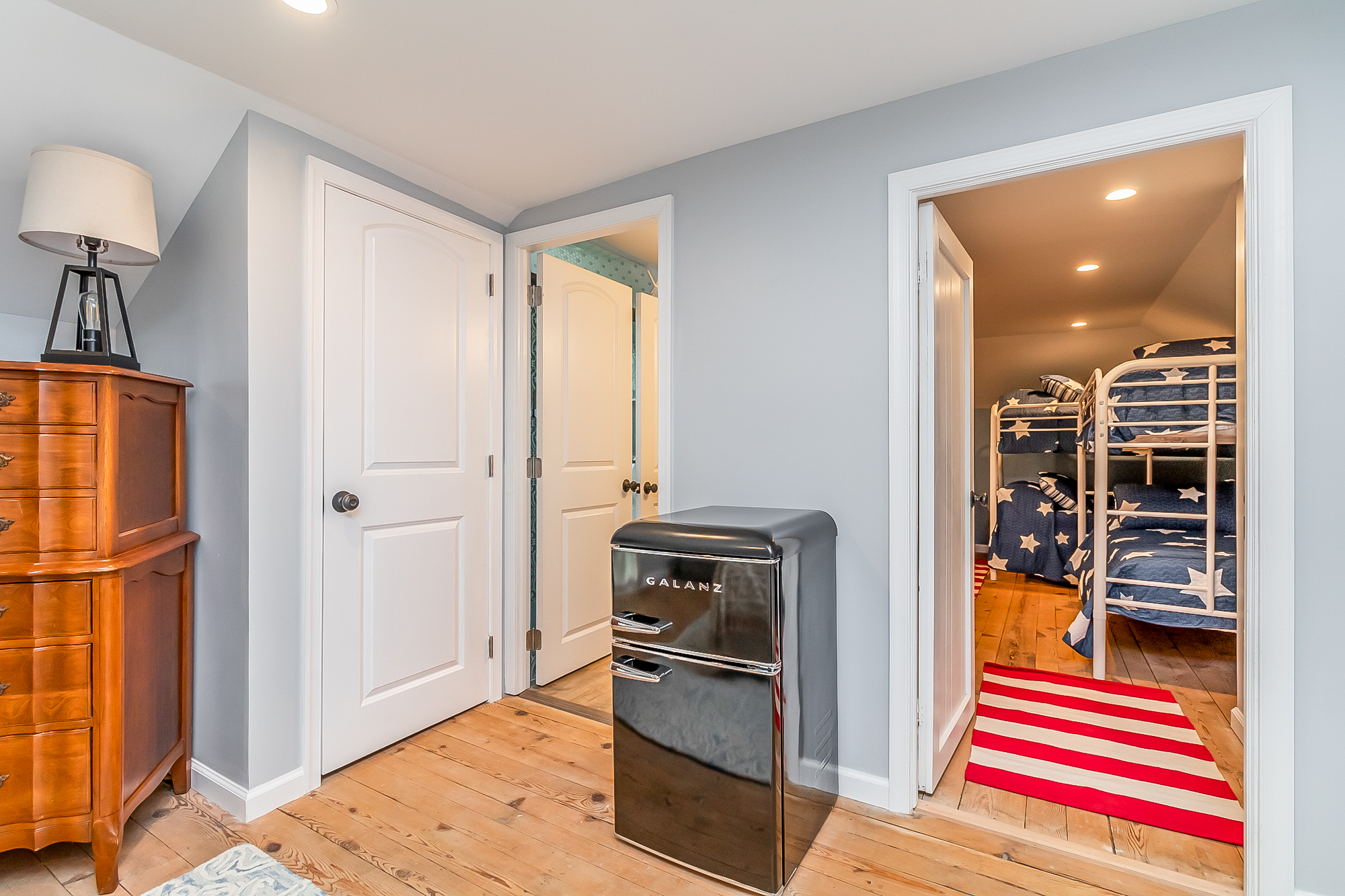 Upstairs landing with mini fridge and doorway to the bunk room