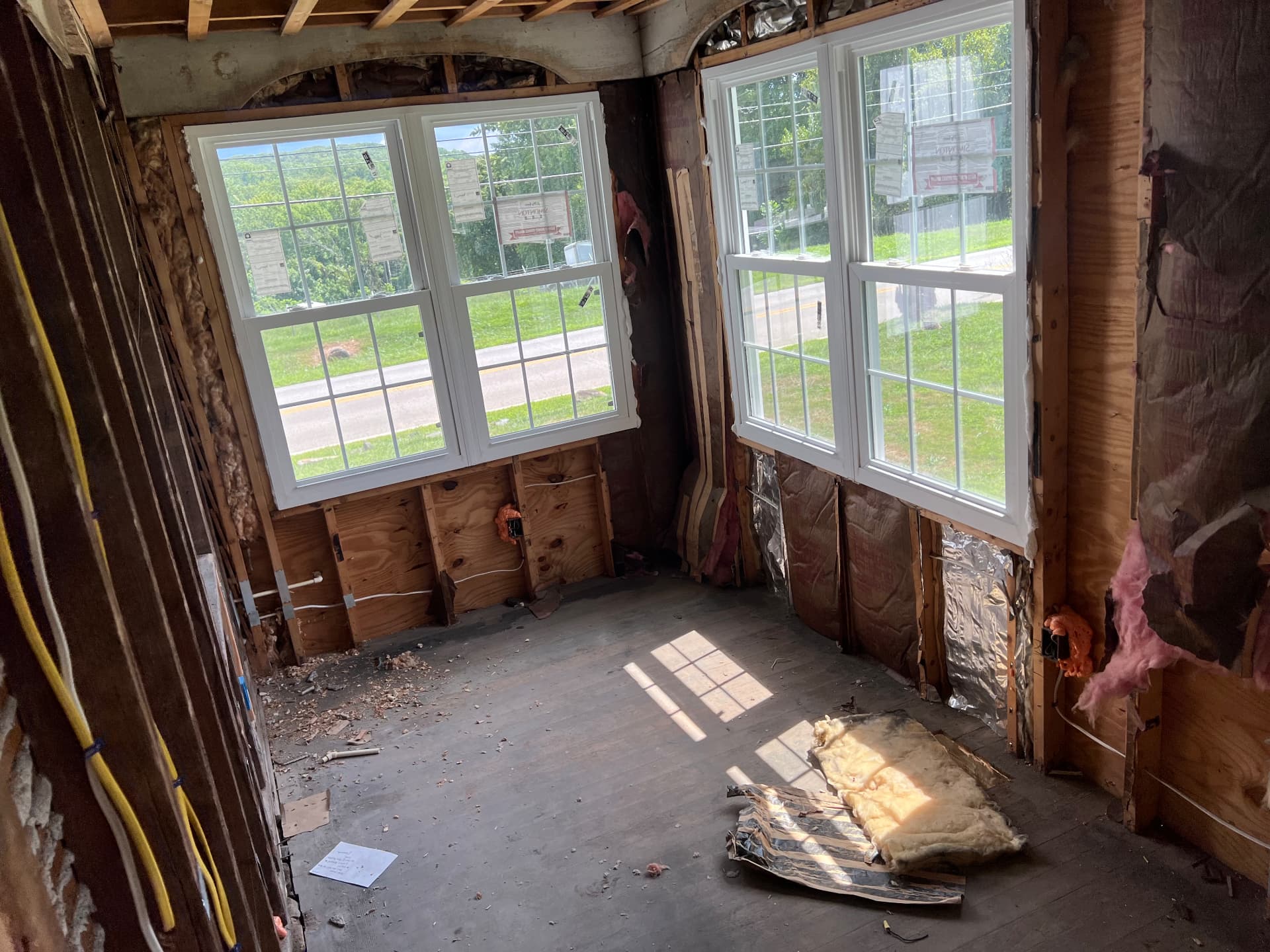 New windows set in the sunroom with walls opened to the studs