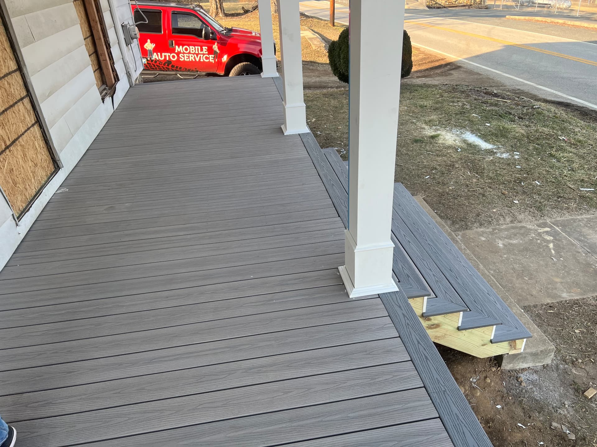 New composite decking installed across the rebuilt front porch