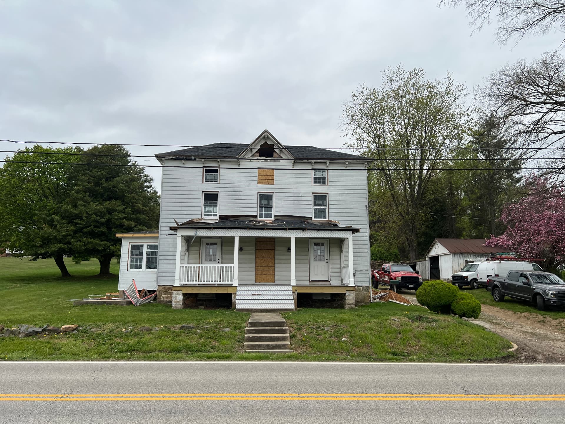 Front of the house with windows out and the porch roof opened up