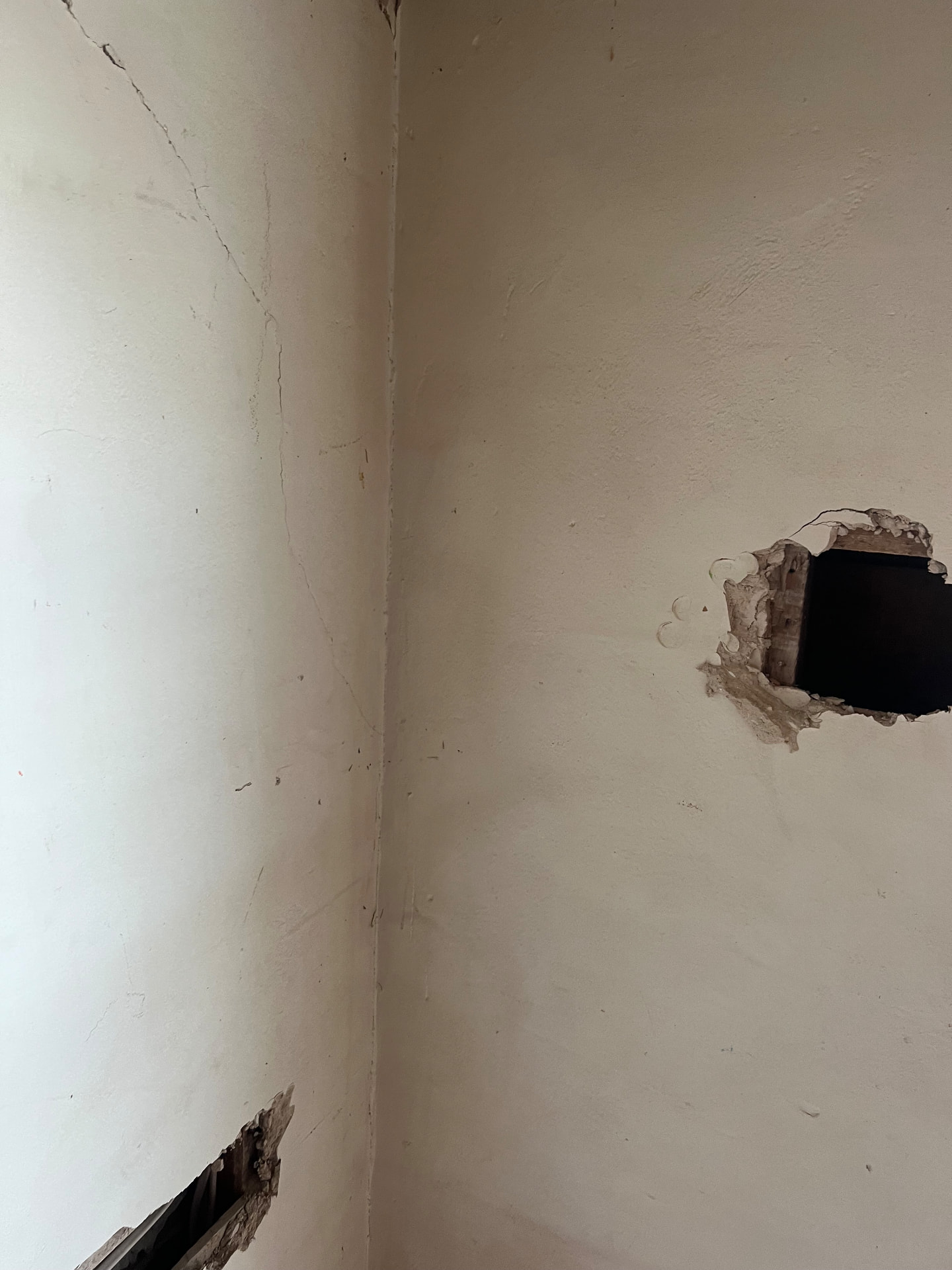 Cracked plaster walls opened up to reach the original framing