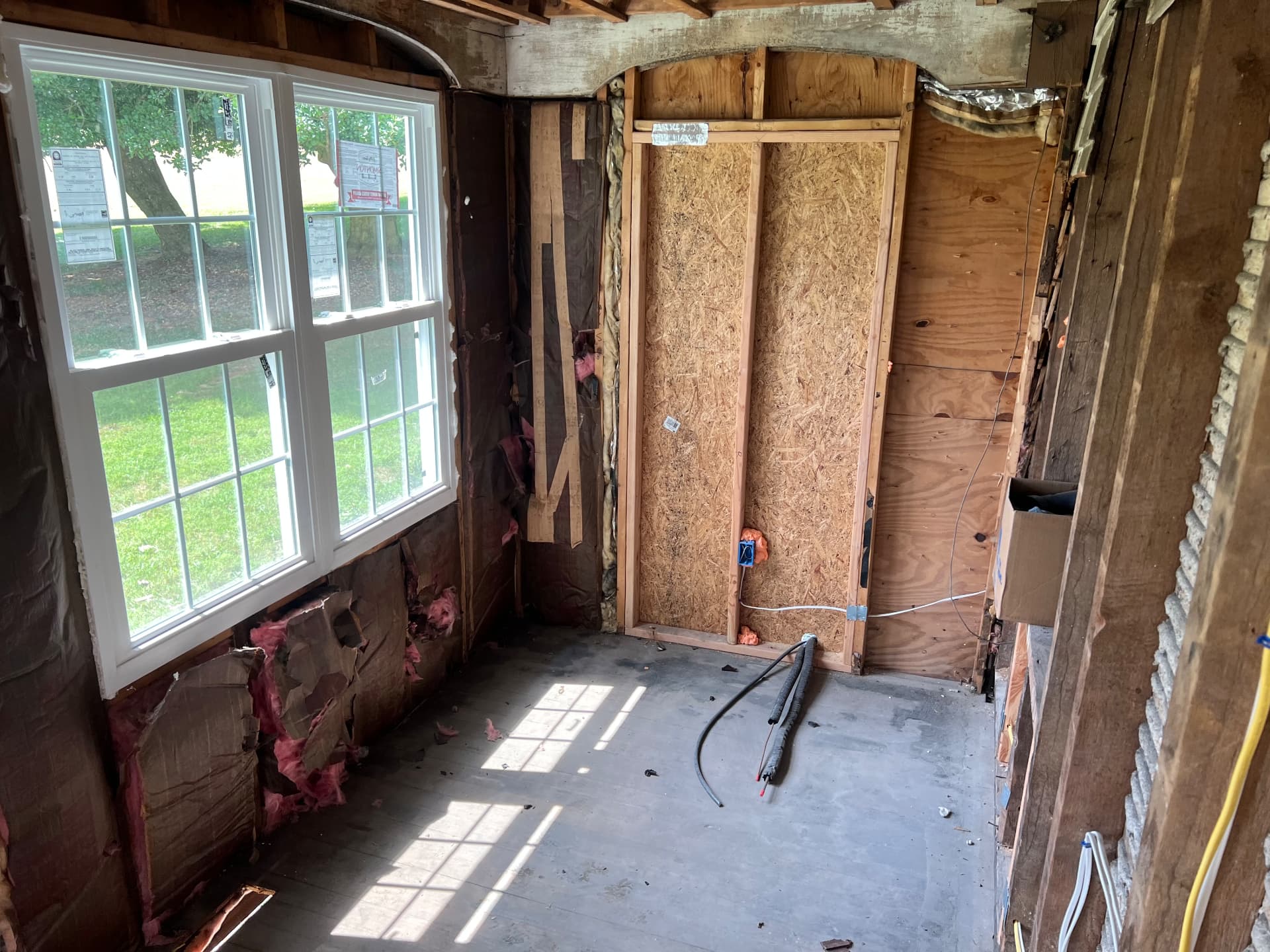 Sunroom corner opened to bare framing and new sheathing
