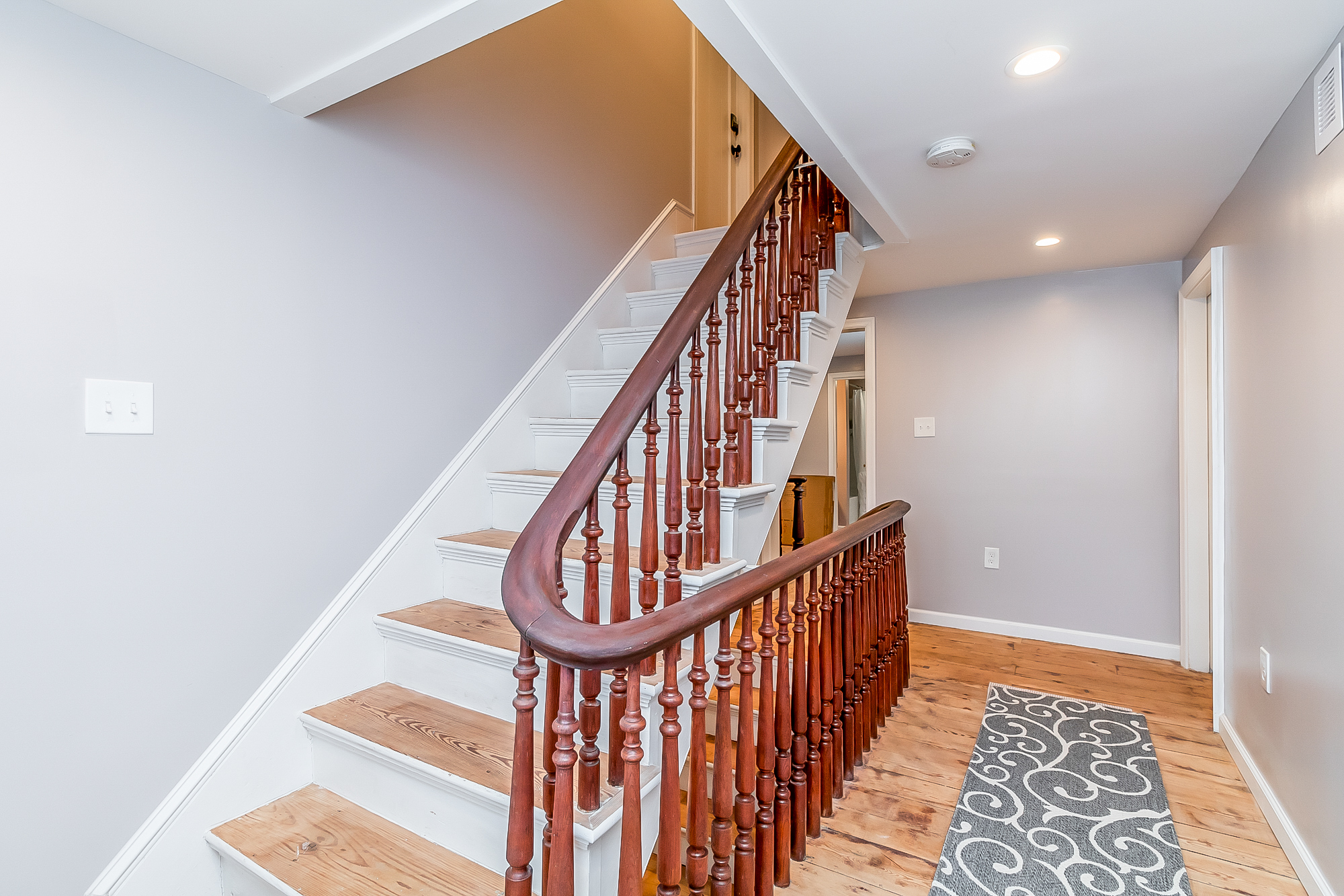 Restored original staircase with turned walnut balusters and pine treads